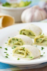 Rolls wrapped bread, tortilla, pita stuffed with avocado cream