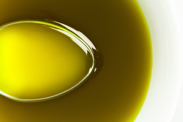 Spoon under extra virgin olive oil