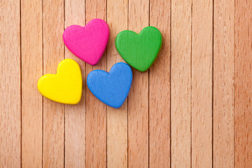 colorful hearts over a wooden background