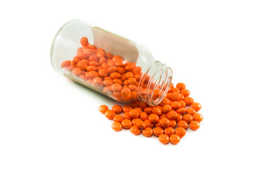 medical orange pills with bottle isolated on white background