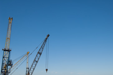 Fototapeta na wymiar Crane boom and hook with sky background