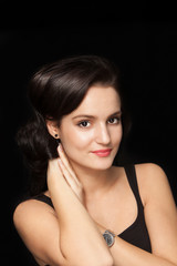 Portrait of a young brunette with soft skin on a black backgroun
