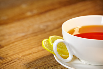 Cup of tea with lemon on the wooden table