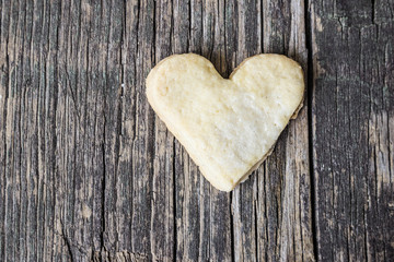 Fototapeta premium Heart of the cookies and the wooden background.