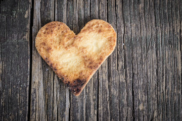 Heart of the cookies and the wooden background.