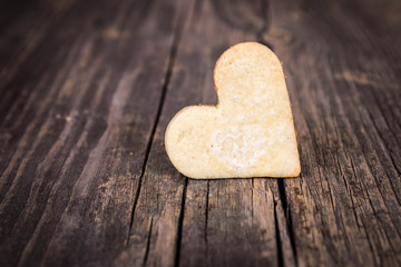 Heart of the cookies and the wooden background.