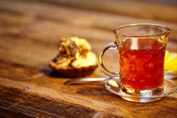 Glass of hot tea on rustic wooden table.