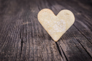 Heart of the cookies and the wooden background.