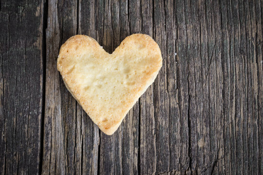 Heart of the cookies and the wooden background.