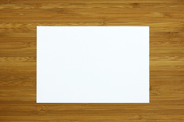white blank card on wooden background