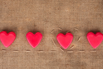 Five  hearts on sackcloth
