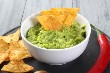 guacamole con nachos sfondo grigio