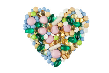 Heart shape made of color pills and capsules, isolated on white