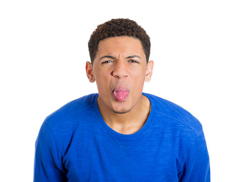 Funny, angry, young, childish rude bully man sticking his tongue