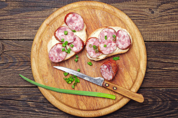 Sandwiches with sausage and onion