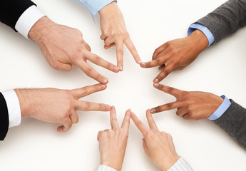 group of businesspeople showing v-sign