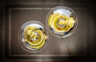 Two olive martini cocktails. The top view