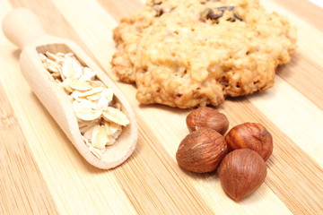 Oatmeal cookies with hazelnut on wooden background