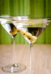 Two olive martini cocktails
