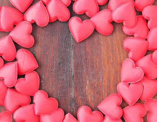 red heart on wood background.