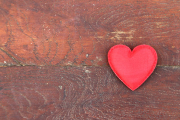 Red heart on wood background