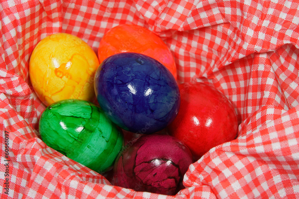 Wall mural colorful eggs in a red and white napkin