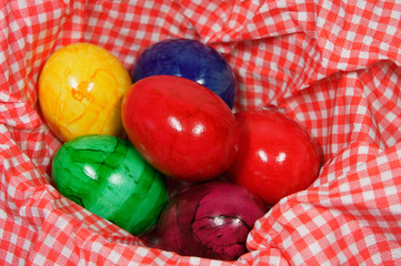 colorful eggs in a red and white napkin