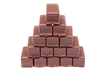 Stack of chocolate sweets on white background