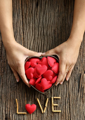 woman hands holding red heart shaped