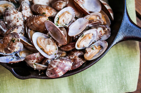 Cast Iron Skillet Of Delicious Fresh Steamer Clams With Garlic A