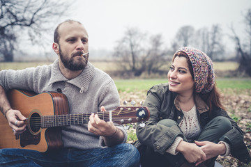 couple in love playing serenade with guitar