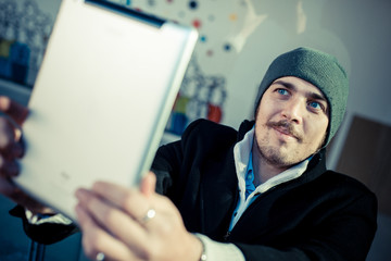 multitasking man using tablet, laptop and cellhpone