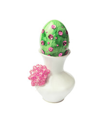 green pink Easter egg with sequins in vase white background