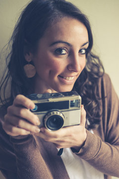 beautiful woman holding old camera