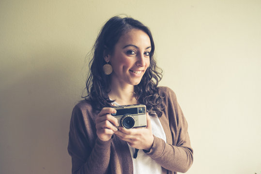 beautiful woman holding old camera