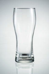 Empty beer glass with reflection isolated.