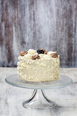 Coconut torte on glass cake stand
