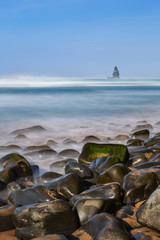 Fototapeta na wymiar Sea stones in foreground in landscape of the sea. Aljezur.