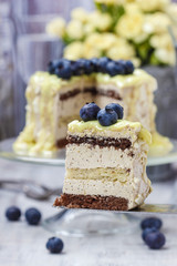 White and dark chocolate layer cake decorated with blueberries
