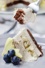 White and dark chocolate layer cake decorated with blueberries