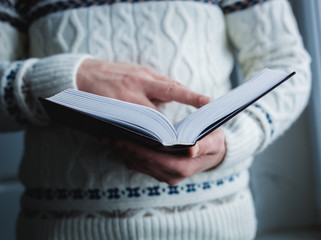 Man reading. Book in his hands.