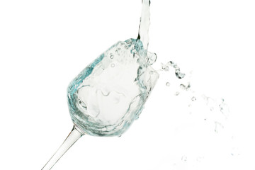 Water splashing in a glass, isolated on white background