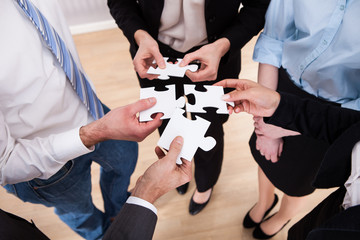Businesspeople Holding Jigsaw Puzzle
