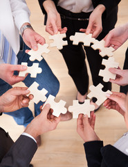 Business People Holding Jigsaw Puzzle