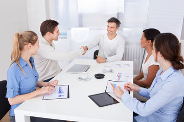 Businesspeople Shaking Hands In A Meeting