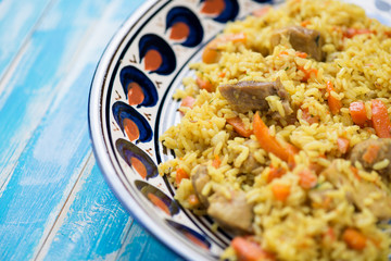 Ceramic dish with eastern cuisine pilaf, horizontal shot