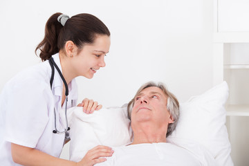 Female Doctor With Senior Male Patient
