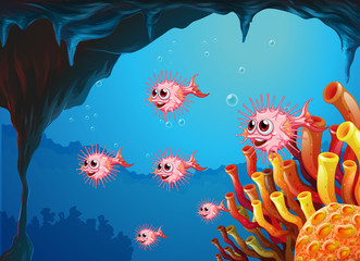 Obraz na płótnie Canvas A school of puffer fishes inside the sea cave