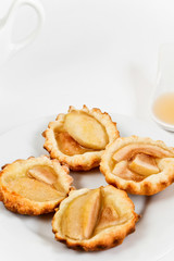 Simple tartlets with poached pear and syrup
