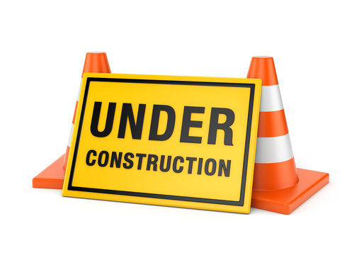 Under construction sign and two road cones